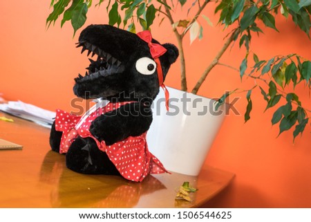 black teddy bear in red dress