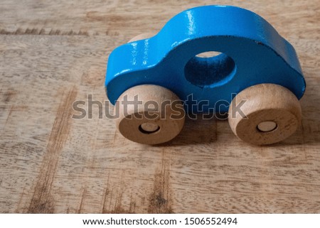 Small blue car on wooden table