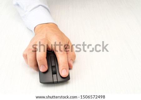 Businessman using computer. Picture of man hand  with wireless computer mouse