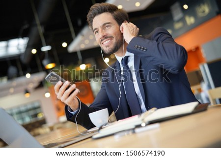 Businessman talking on phone at airport waiting room Royalty-Free Stock Photo #1506574190