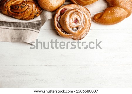 Different delicious fresh pastries on white wooden background, flat lay. Space for text