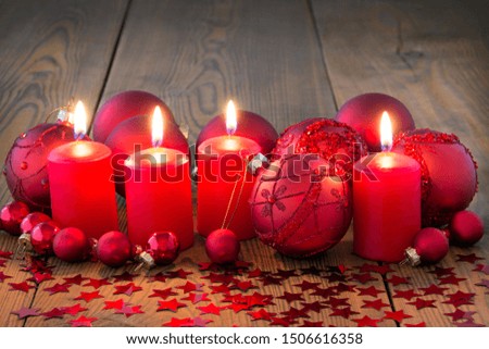 Advent wreath with burning candles and wooden background