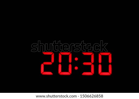 Red digital clock on black.