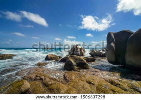 Surf on the rocks of La Digue island, Seychelles