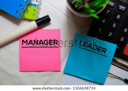 Manager or Leader on sticky Notes isolated on office desk.
