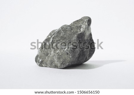 Single natural stone on a white background. Macro photo of rocks