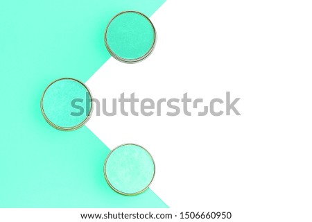 Eyeshadows in different shades of mint on trendy mint and isolated white background. Flat lay. Copy space.