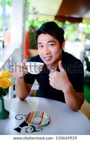 Young man drinking a cup of coffee