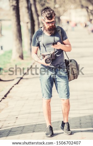 Photographer with beard and mustache. Tourist shooting photos. Content creator. Man bearded hipster photographer. Old but still good. Photographer hold vintage camera. Modern blogger. Manual settings.