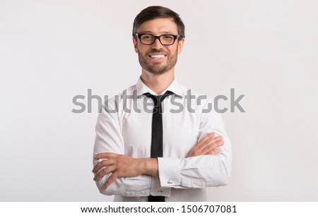 Cheerful Businessman Smiling At Camera Crossing Hands On Yellow Background. Studio Shot, Copy Space