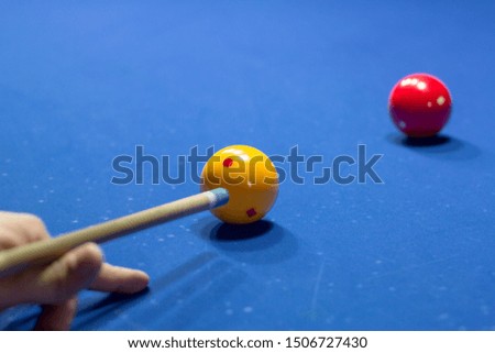 Unrecognizable man playing billiard taking aim