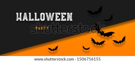 Halloween holiday background with bats flying over orange background. Flat lay, top view, copy space