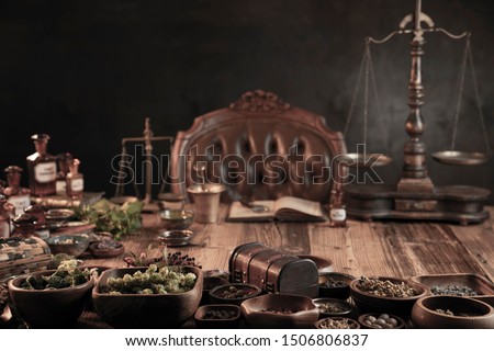 Natural medicine background. Dry and fresh herbs in bowls. Rustic wooden table, brass mortar and scales. Royalty-Free Stock Photo #1506806837