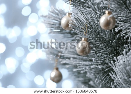 Decorated Christmas tree against blurred lights on background. Bokeh effect