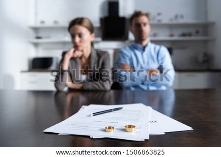 selective focus of couple sitting at table with divorce documents Royalty-Free Stock Photo #1506863825