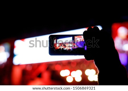 Supporters recording at concert - candid image of crowd at rock concert