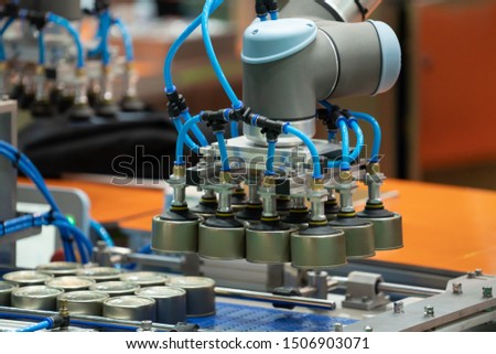 Industrail Robotic Arm use vacuum system to holding aluminum can. Industrial Robotic arm technology installed to aluminium industry line production in a factory. Royalty-Free Stock Photo #1506903071