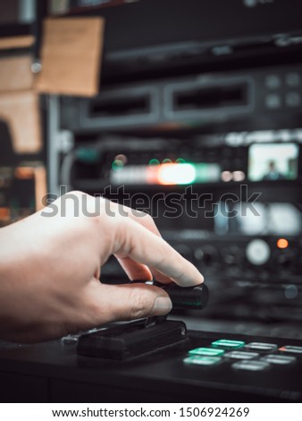 Close up hand on video switcher panel