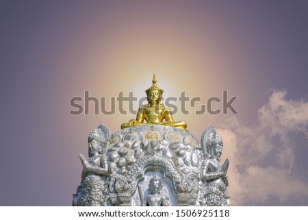 Gold color Buddha image on silver pedestal with an angel statue around, colorful background created with a computer program