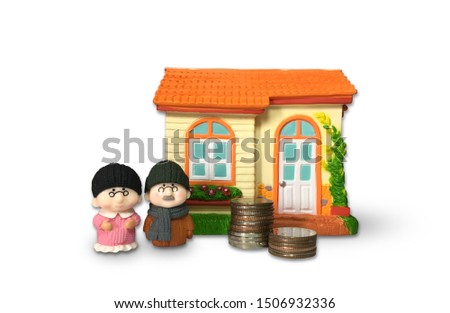 Thai baht coins, old man dolls and houses on a white background. Idea to save money for retirement.