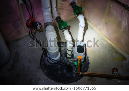 sump pump manhole with water backup viewed with a flashlight Royalty-Free Stock Photo #1506971555