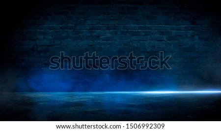 Blue dark background of empty foggy street with wet asphalt, illuminated by a searchlight, laser beams, smoke
