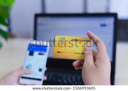 woman holding credit card and use phone for with shopping online. Online payment concept. - Image