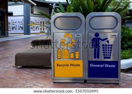 New metal garbage trash for general waste and recycle waste at outdoor area of community mall.