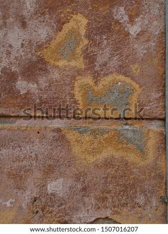 closeup of damages and stained rusty surface in deep purple