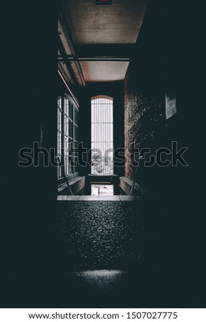 Picture of stairs at the end of a Dark Hallway
