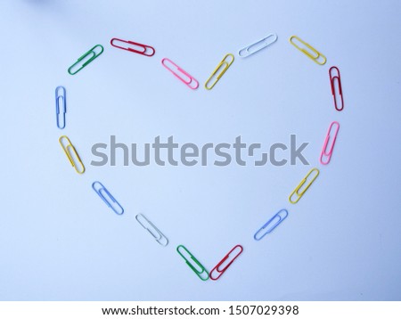 Heart from paper clip on white background