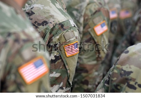American Soldiers and Flag of USA on soldiers arm. US Army. Veteran Day Royalty-Free Stock Photo #1507031834