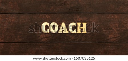 forming the word coach with wooden letters