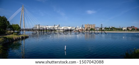 Looking northwards over the artificial lake from the ornate bridge in King's Gardens. Bridge that crosses the lake between Southport Town Centre and the Ocean Plaza on the sea front. Royalty-Free Stock Photo #1507042088