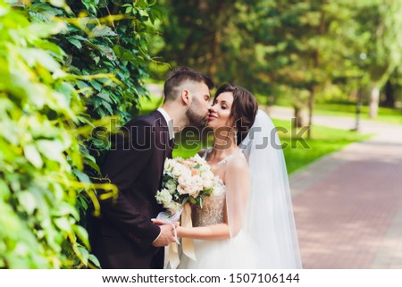 happy bride and groom at a park on their wedding day.