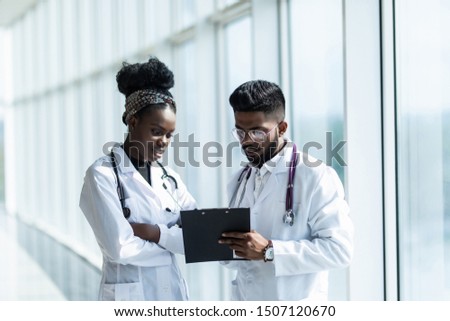Portrait of doctors looking at a document in an office