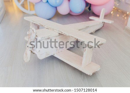 antique tin toy plane on wooden background.