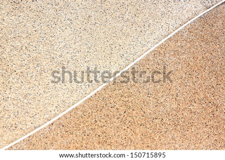 Two stone color with white stripe separating them of background.