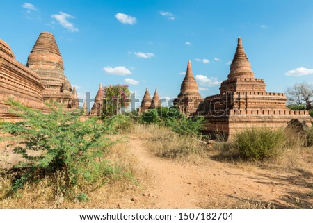 Wide angle picture of narrow streets between the old buddhist temples in Bagan, a famous touristic destination of Myanmar