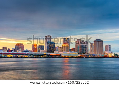 New Orleans, Louisiana, USA downtown skyline on the Mississippi River at dusk.