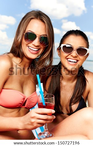 Two young girls enjoying rest on the beach