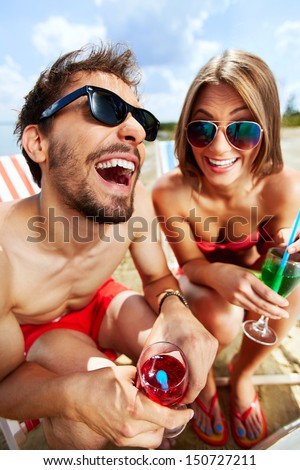 Relaxed young lovers having fun on the beach on a sunny day