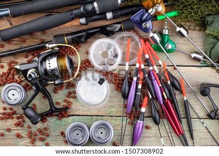 Spinning and reels, accessories for fishing on the table in composition