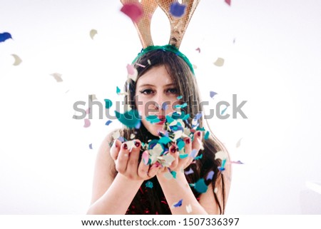 Teenage girl partying celebrating New Year's Eve and Christmas at a party