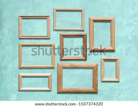 old wooden frames on blue wall