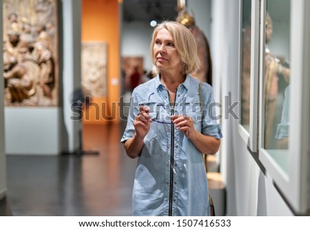 woman visitor in the historical museum looking at exhibit