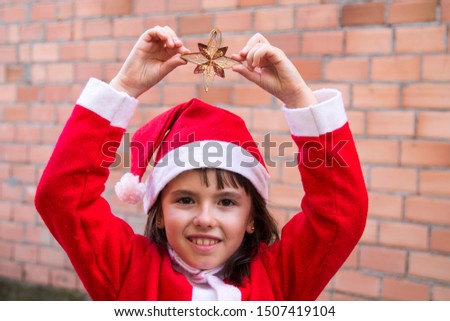 Children dressed as Santa Claus and with Christmas star in their hands. Christmas greeting