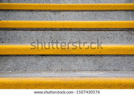 Background of concrete stairs with yellow stripes 