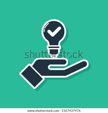 Blue Light bulb in hand icon isolated on green background. Concept of idea.  Vector Illustration