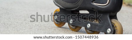 banner of Roller skate on Asphalt in summer Close-up.